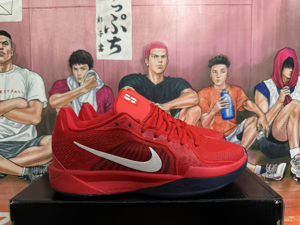 Side view of a red Nike basketball shoe with a silver Swoosh and dark outsole.