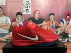Side view of a red Nike basketball shoe with a silver Swoosh and dark outsole.