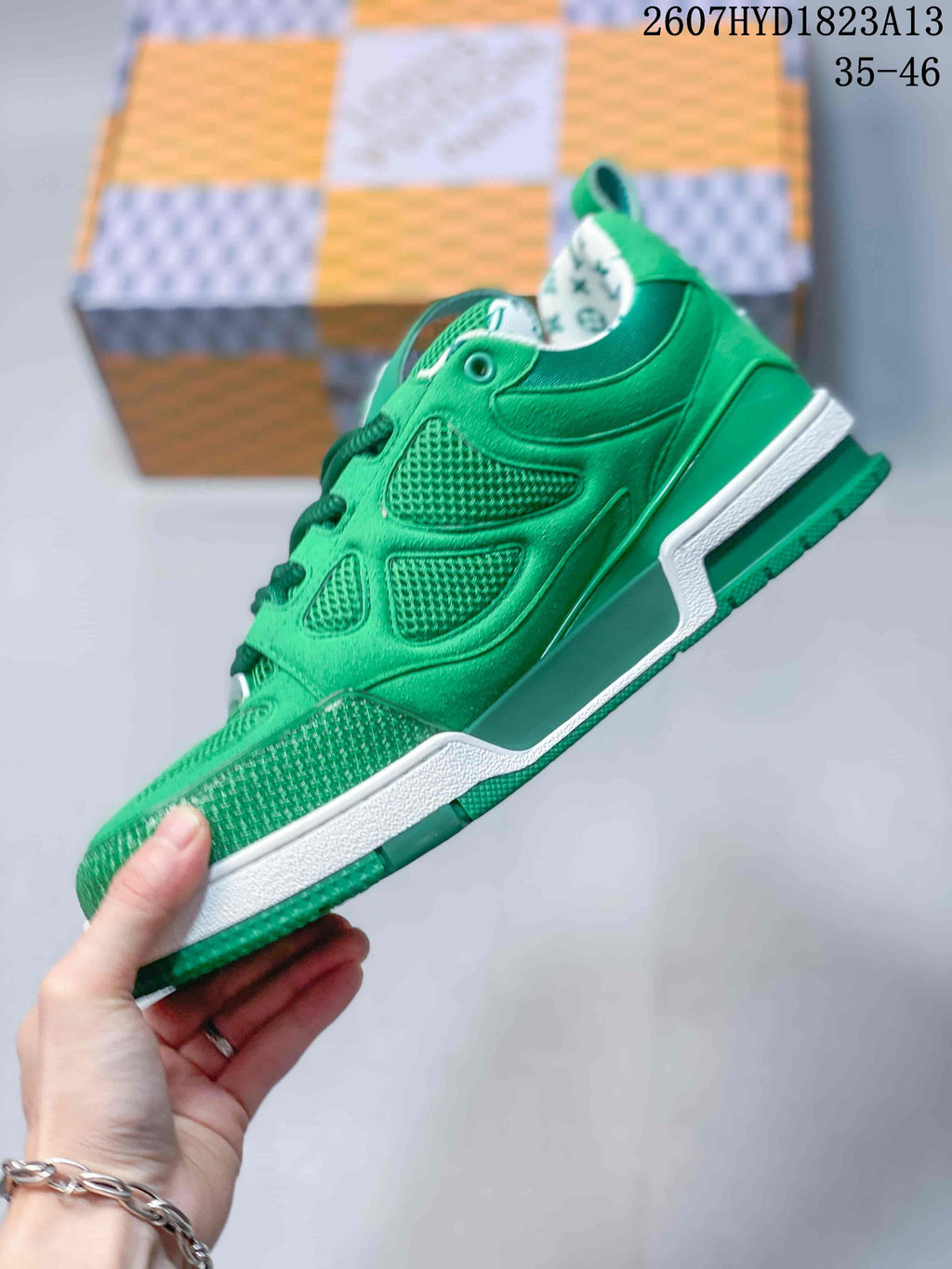 Side view of the green sneaker showing layered panels, mesh inserts, green upper and contrasting white midsole.