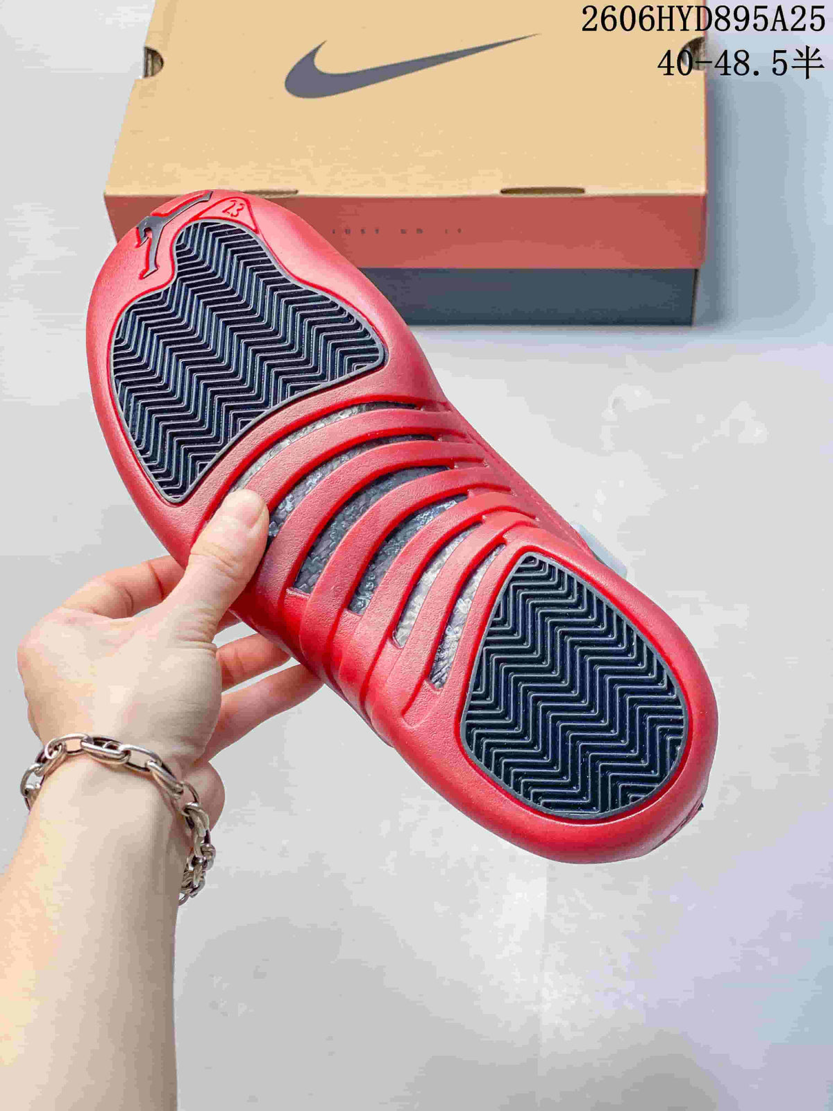 Close-up of the red and black patterned outsole of a Jordan Air Jordan 12 sneaker