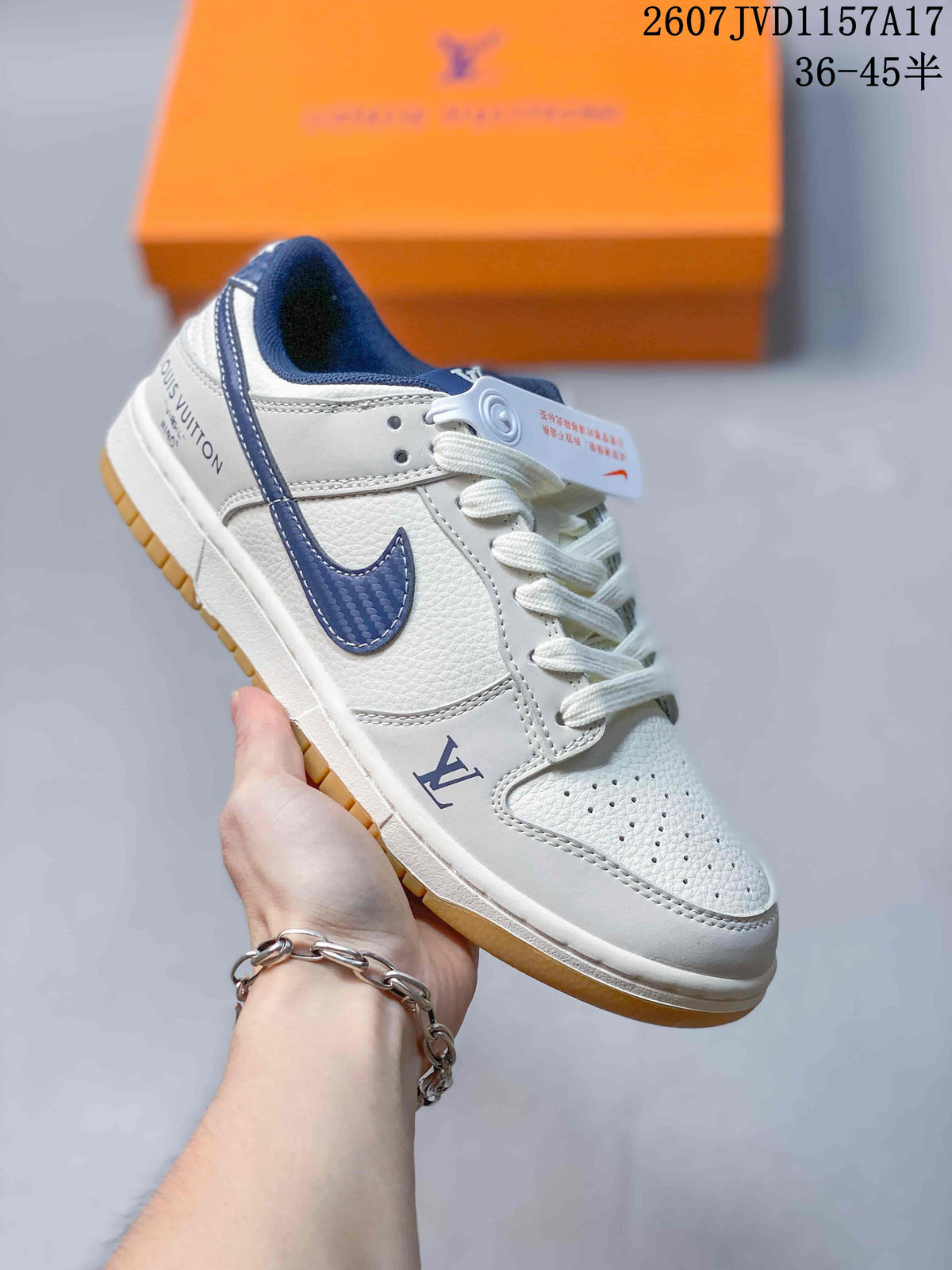 Angled side view of the white and navy sneaker showing the Louis Vuitton detail near the forefoot, navy Swoosh, and gum outsole.