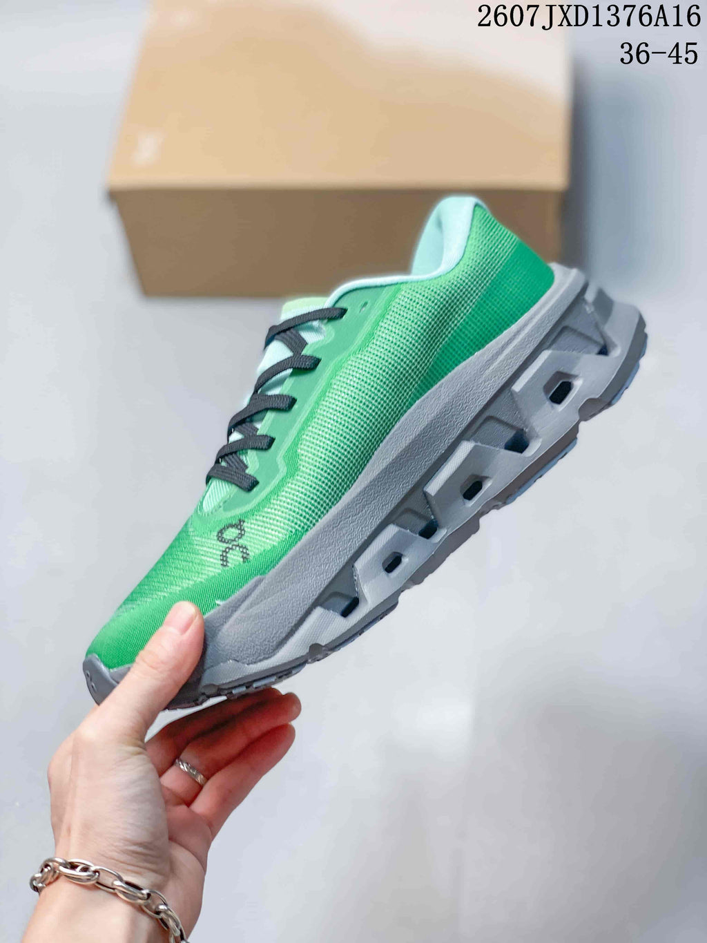 Side profile of the green sneaker showing the textured upper, black accents, and segmented gray sole.