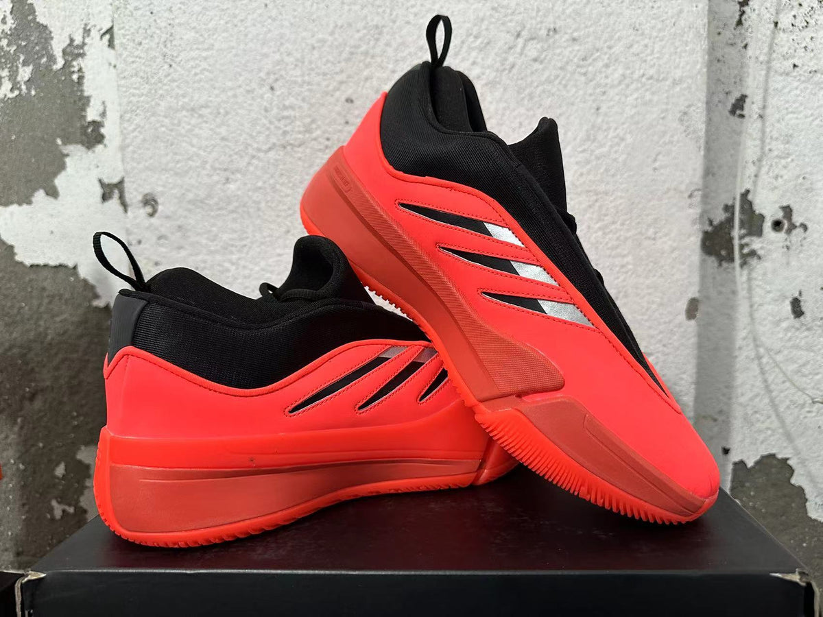 Red-and-black Dame 9 basketball shoes displayed from the side