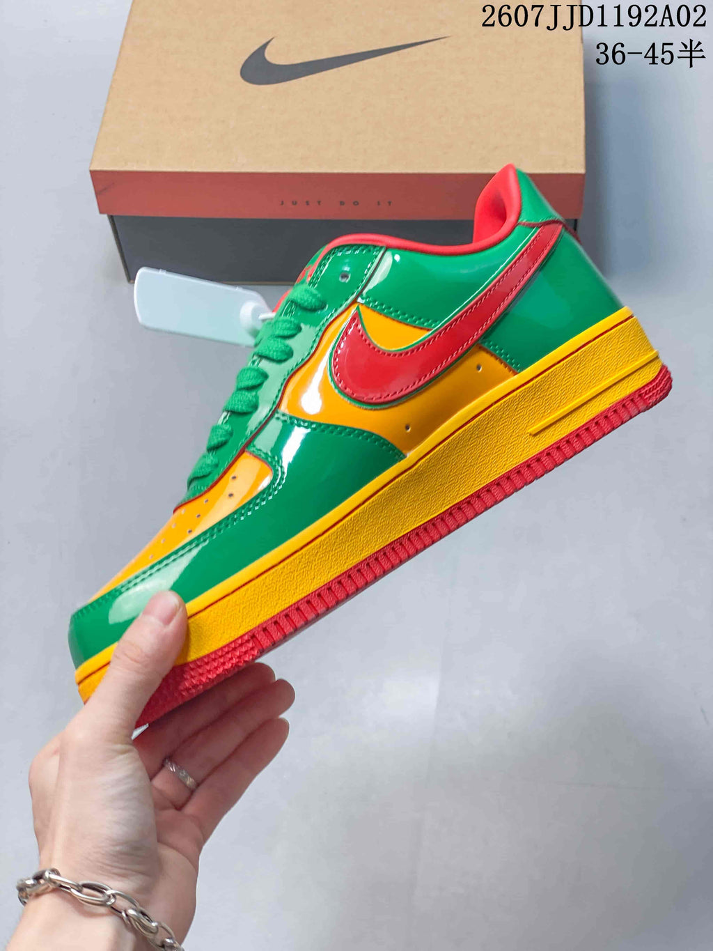 Side view of the low-top sneaker with green, yellow, and red panels