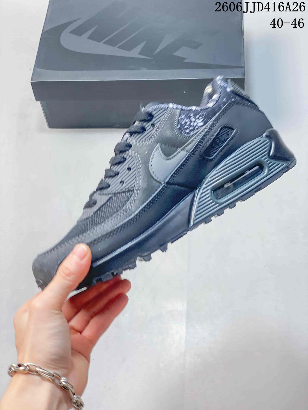 Side view of the gray sneaker showing the Swoosh, layered panels, heel window detail, and textured outsole.