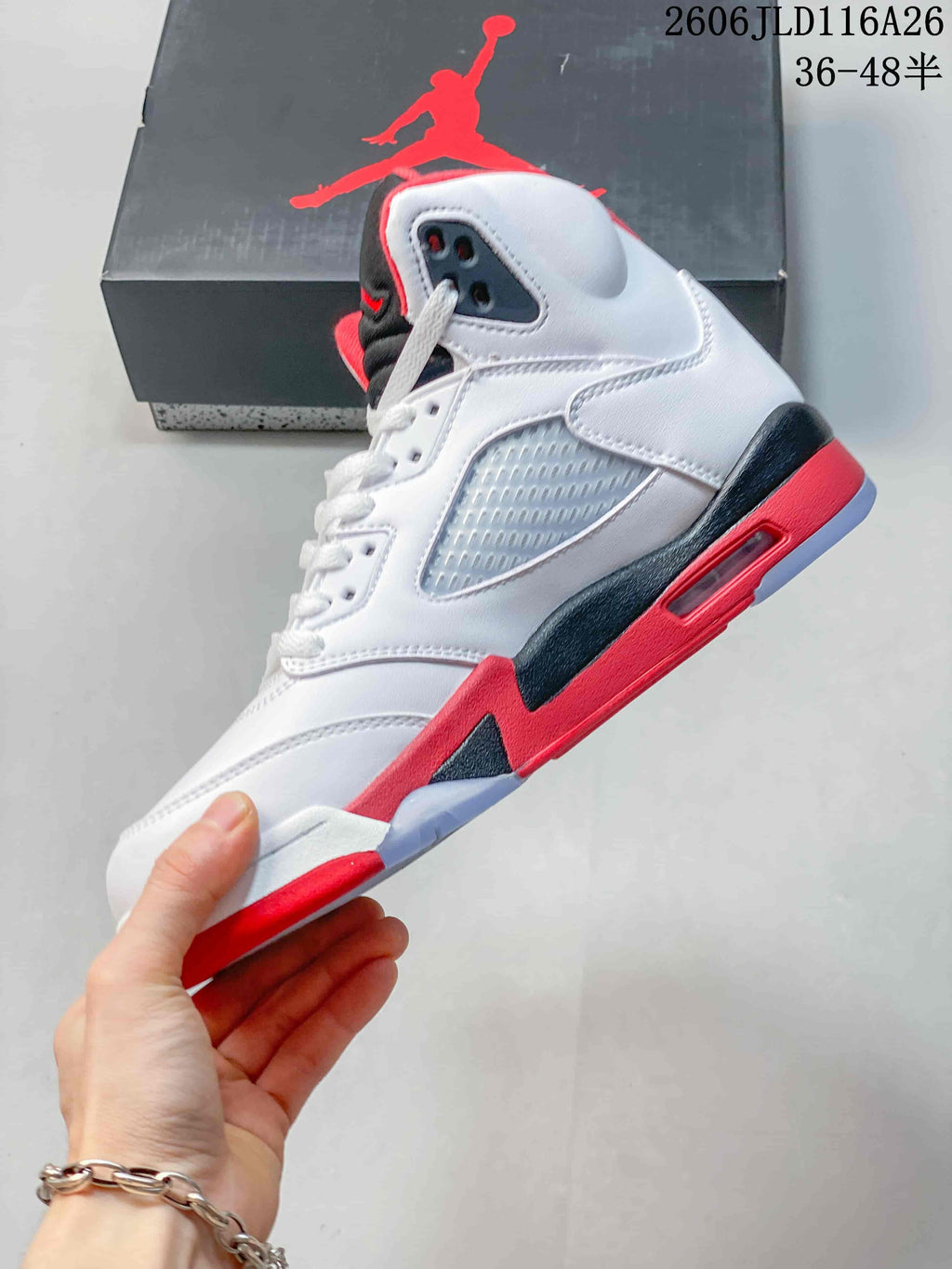 Side view highlighting the mesh panel, high-top collar, and red and black midsole accents