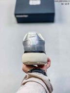 Rear view showing the silver heel and ribbed off-white sole
