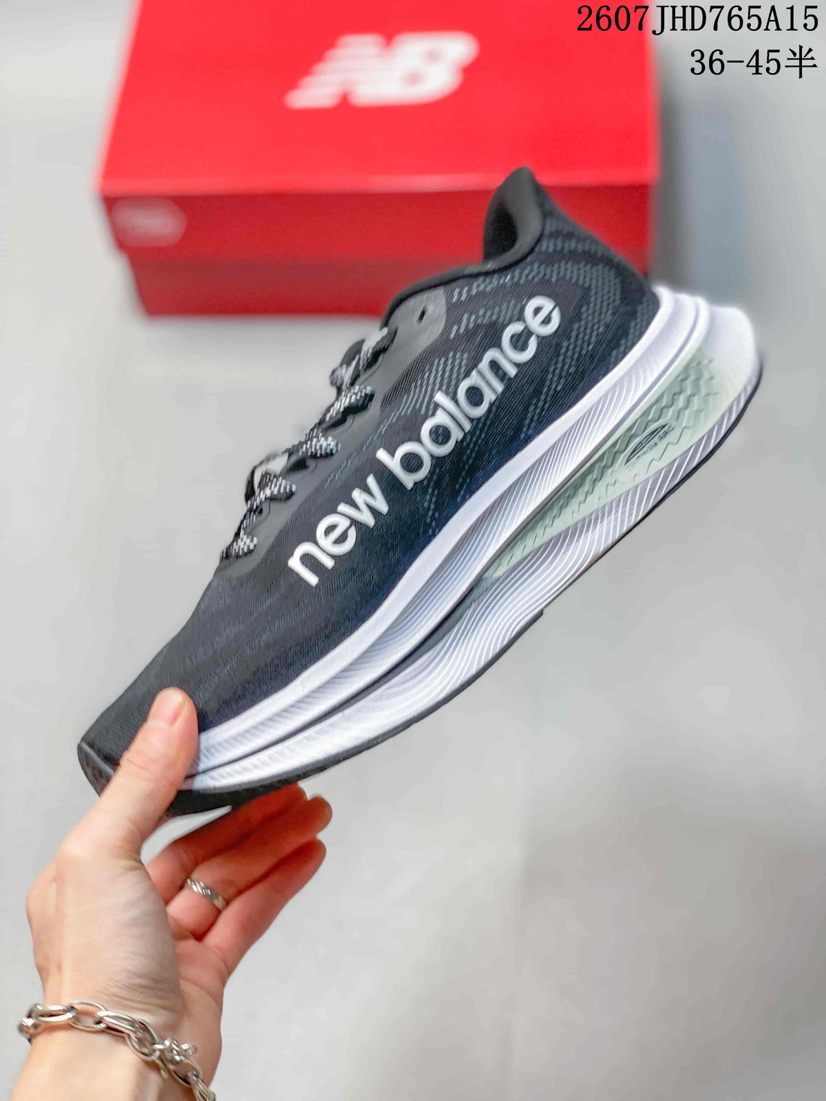 Side profile showing the New Balance logo, dark gray upper and layered white midsole.