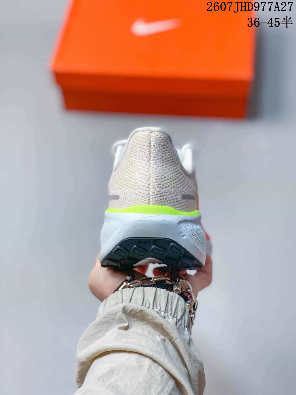 Rear view showing the padded heel, white midsole, neon green accent, and black outsole.