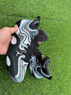 Pair of white, black, and multicolor-patterned Jordan basketball shoes on grass