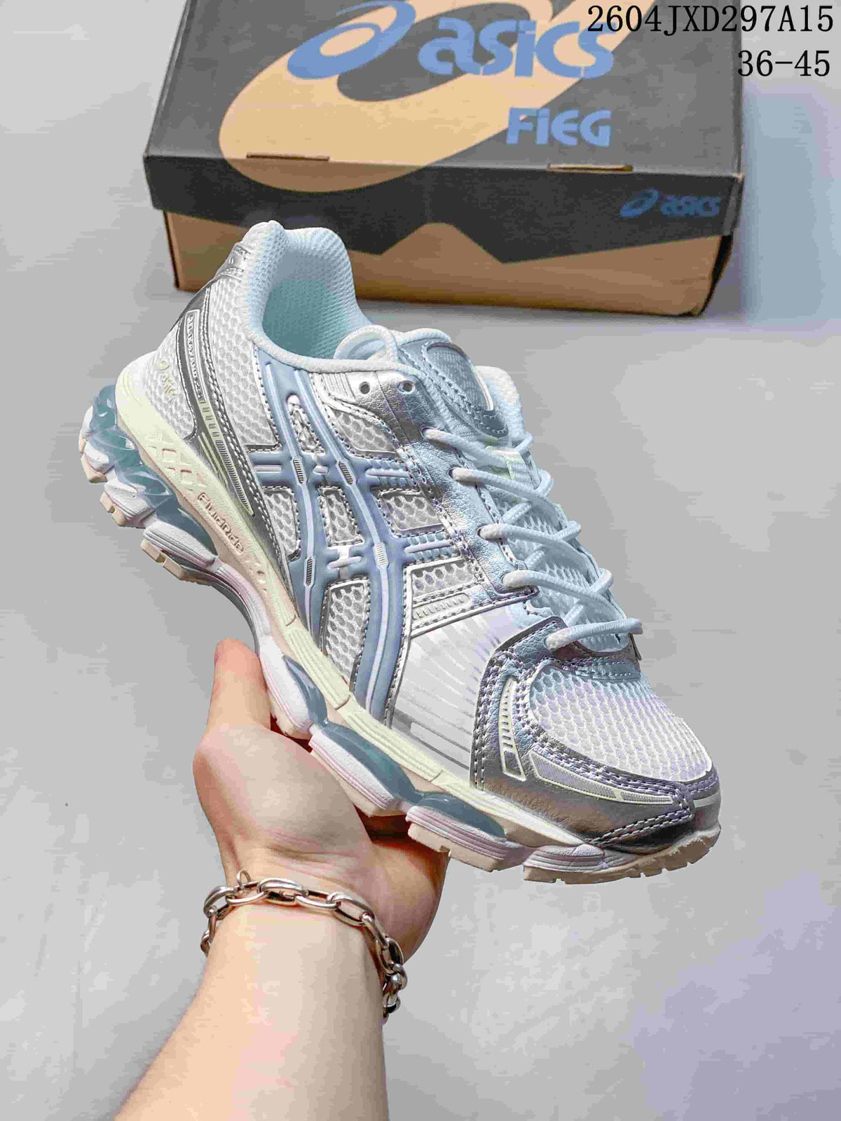 Angled side view of the pale silver and blue sneaker