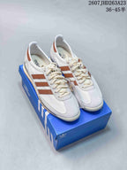 Pair of white and brown adidas Originals SL 72 OG LT W sneakers displayed on a blue adidas shoebox.