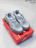 Pair of silver and gray Nike Shox Ride 2 sneakers on a red shoe box