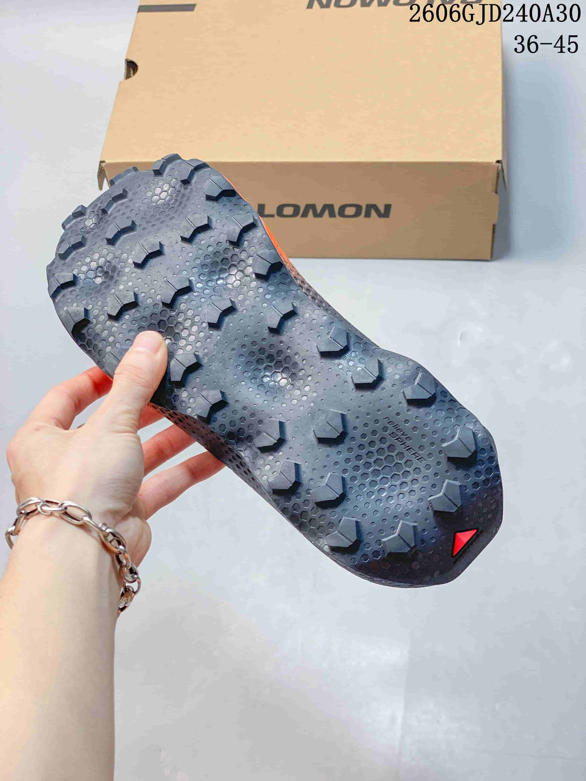 Close-up of the Salomon Ultra Glide 4 outsole showing its lugged tread pattern.