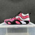 Side view of pink, white, and black low-top sneakers with a patterned upper