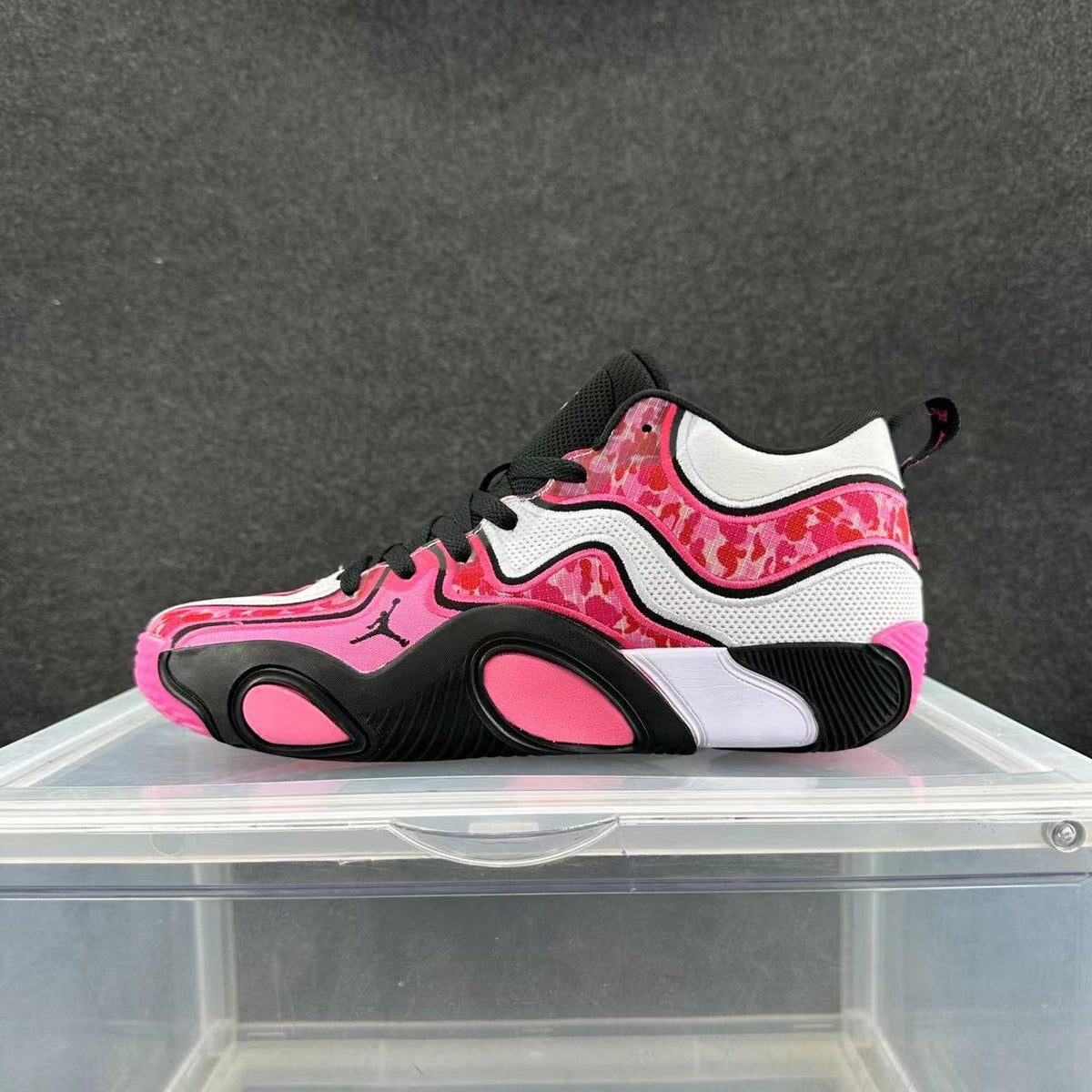 Side view of pink, white, and black low-top sneakers with a patterned upper