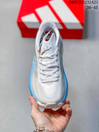 Top view of the white lace-up sneaker with gray side panels and blue edging.