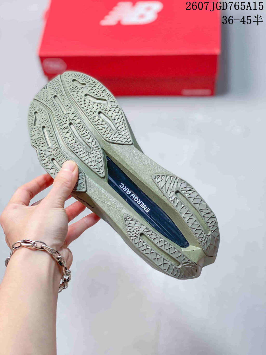 Close view of the shoe outsole showing a geometric tread pattern and a central dark insert.