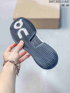Underside of an On sneaker showing a dark patterned rubber outsole with herringbone-style tread.