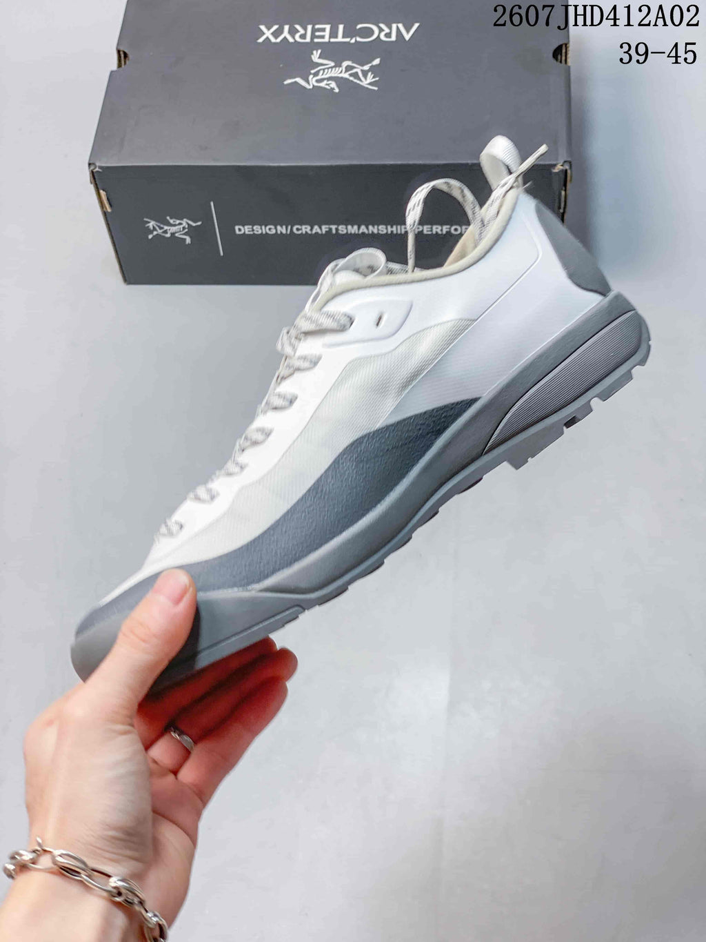 Side profile of a white and gray low-cut shoe