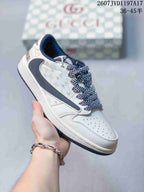 Close side view of a white low-top sneaker showing the grey side Swoosh, patterned laces, perforated toe box and padded collar.