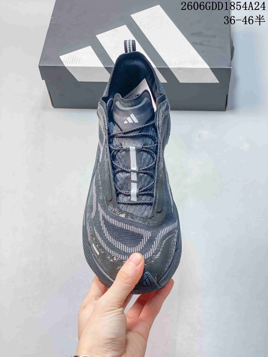 Top view showing the laces and tongue of a dark gray Adidas shoe