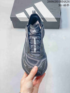 Top view showing the laces and tongue of a dark gray Adidas shoe