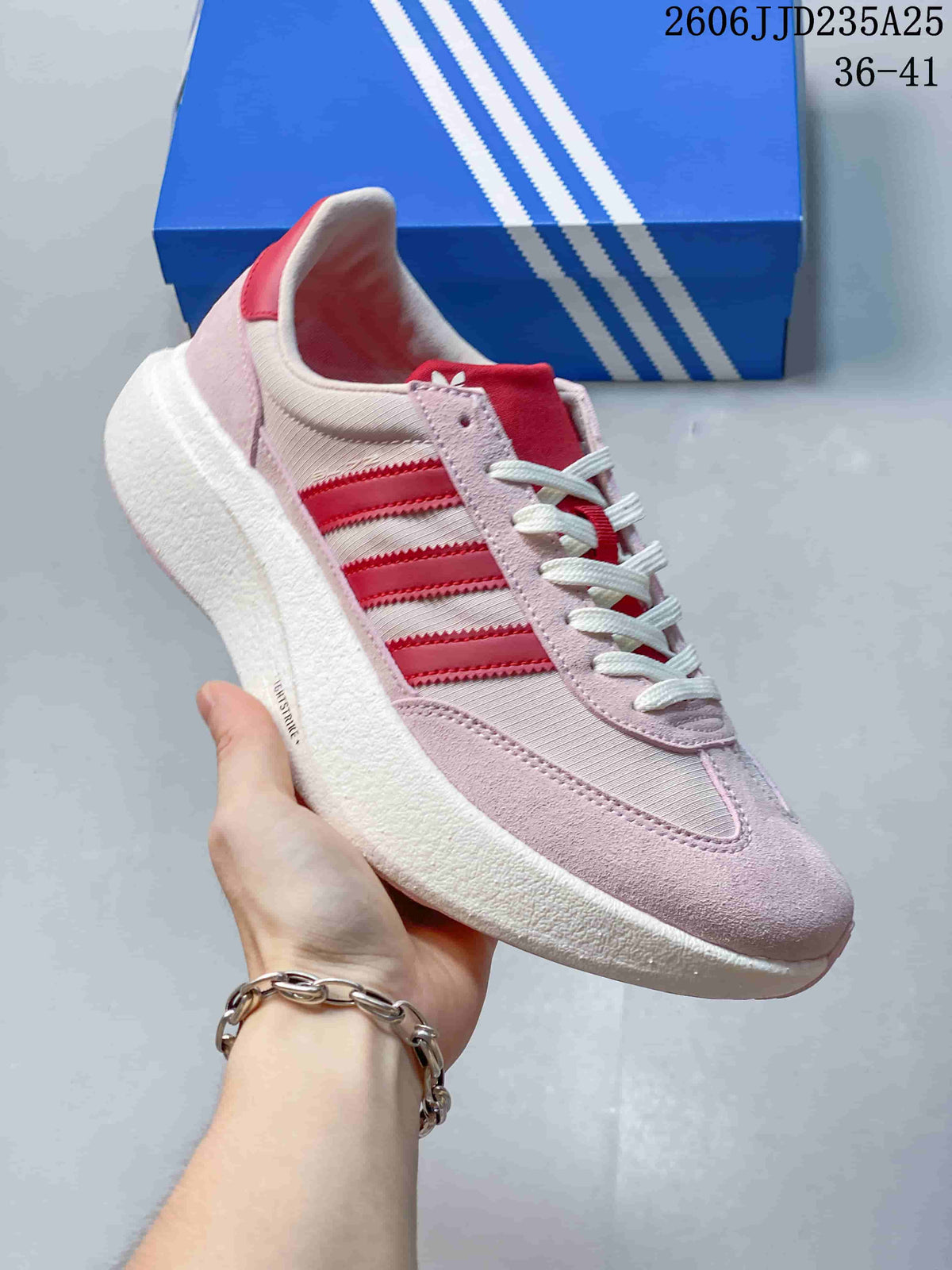 Side view of a pale pink Adidas Adizero SL 72 Pro sneaker with red stripes