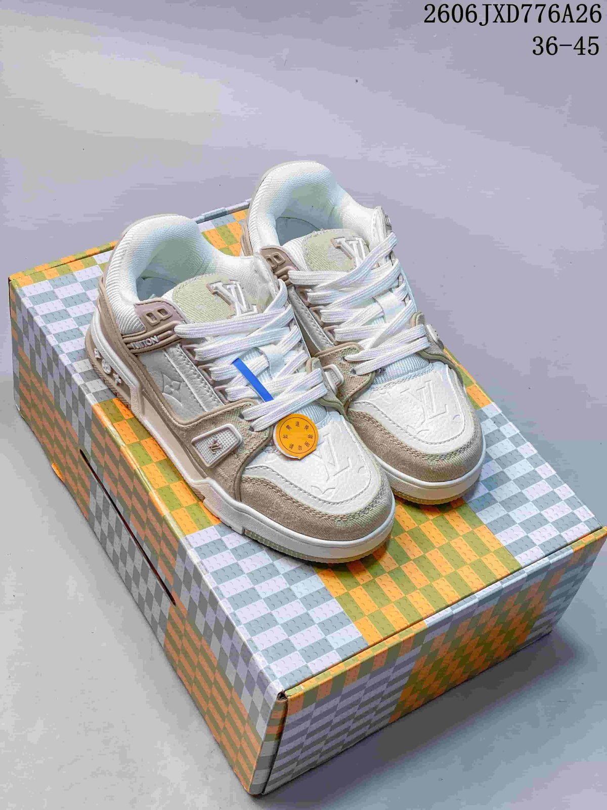 White and beige Louis Vuitton Trainer low-top sneakers shown on a patterned box