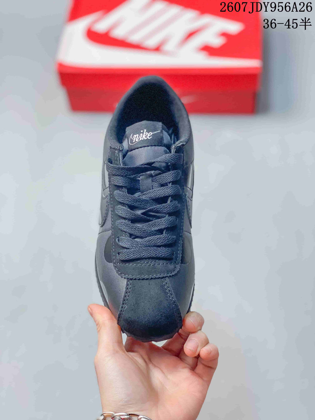 Top view of the black lace-up sneaker showing the tongue, laces, toe box, and stitched upper panels.