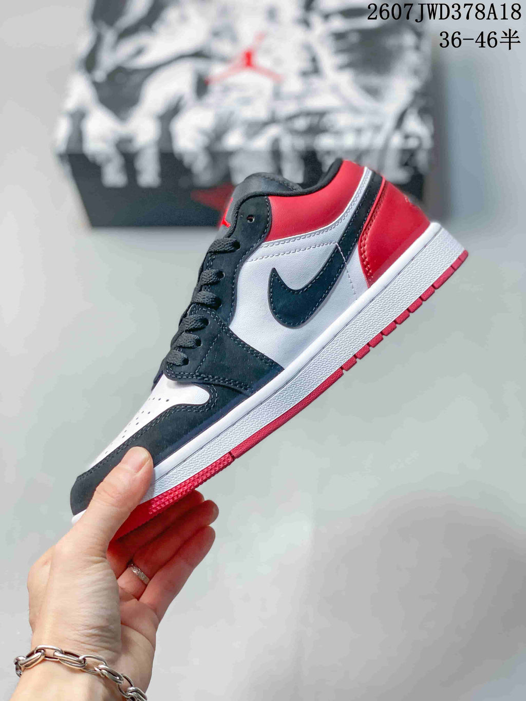 Side profile highlighting the black overlays, white panels, red heel, and swoosh-shaped side detail