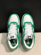 Top-down view of the pair showing white laces, perforated toe panels, green overlays, and branded insoles.