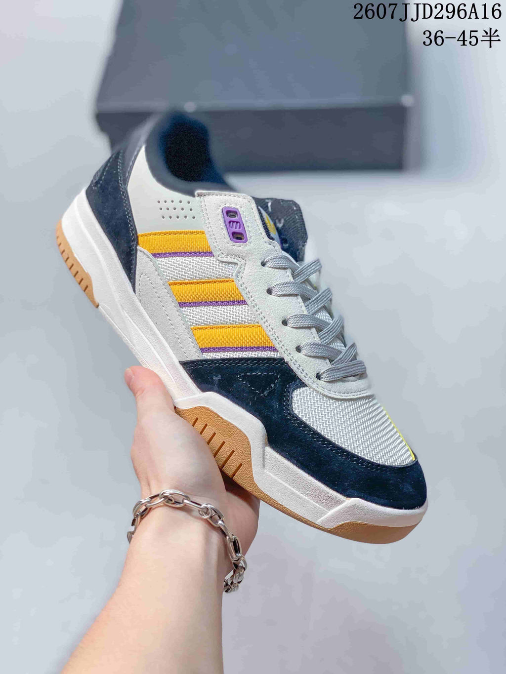 Angled side view of the adidas sneaker showing its low-top profile, lace-up closure, side stripes, and layered outsole.