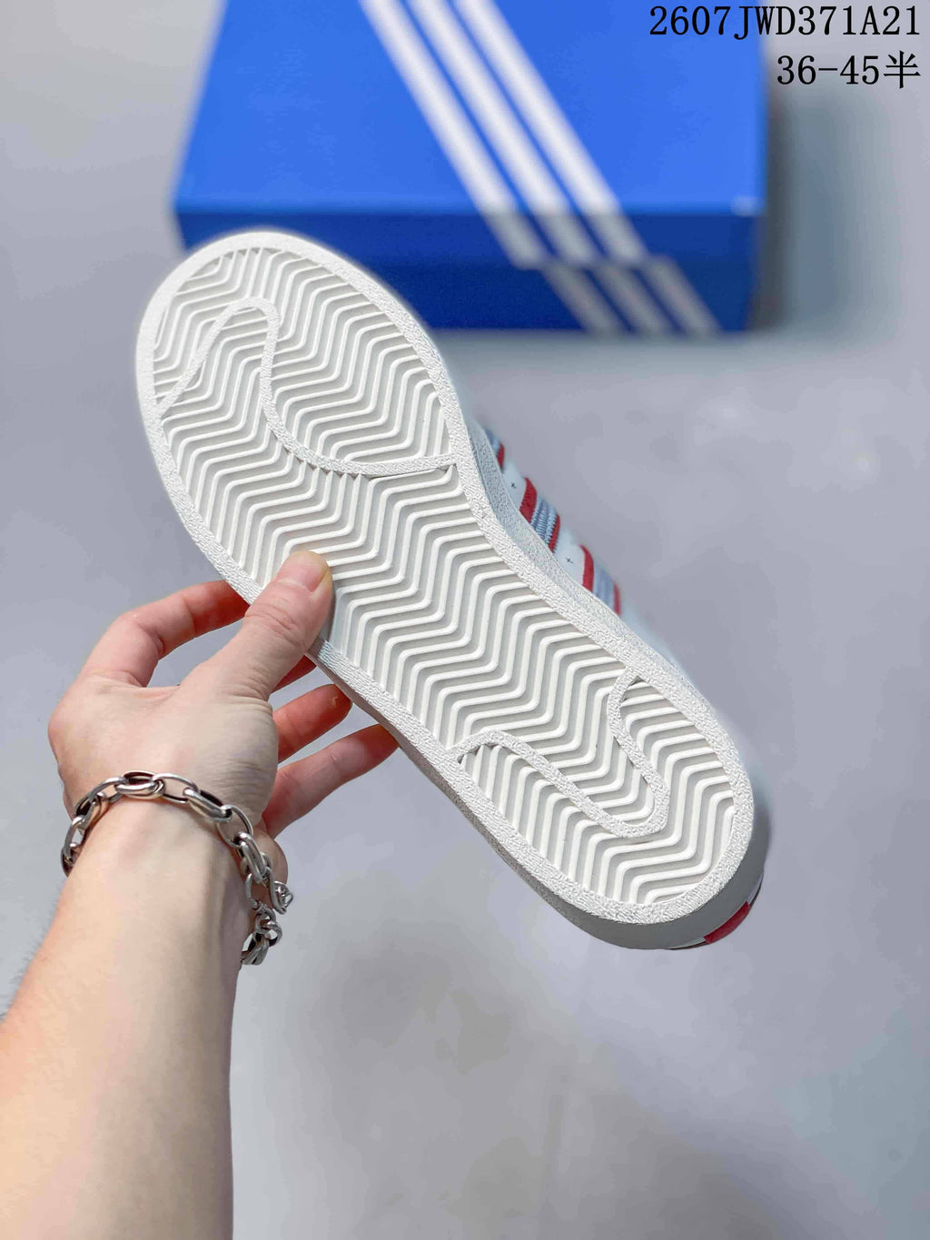 Close-up of the white rubber outsole showing a repeating zigzag tread pattern.