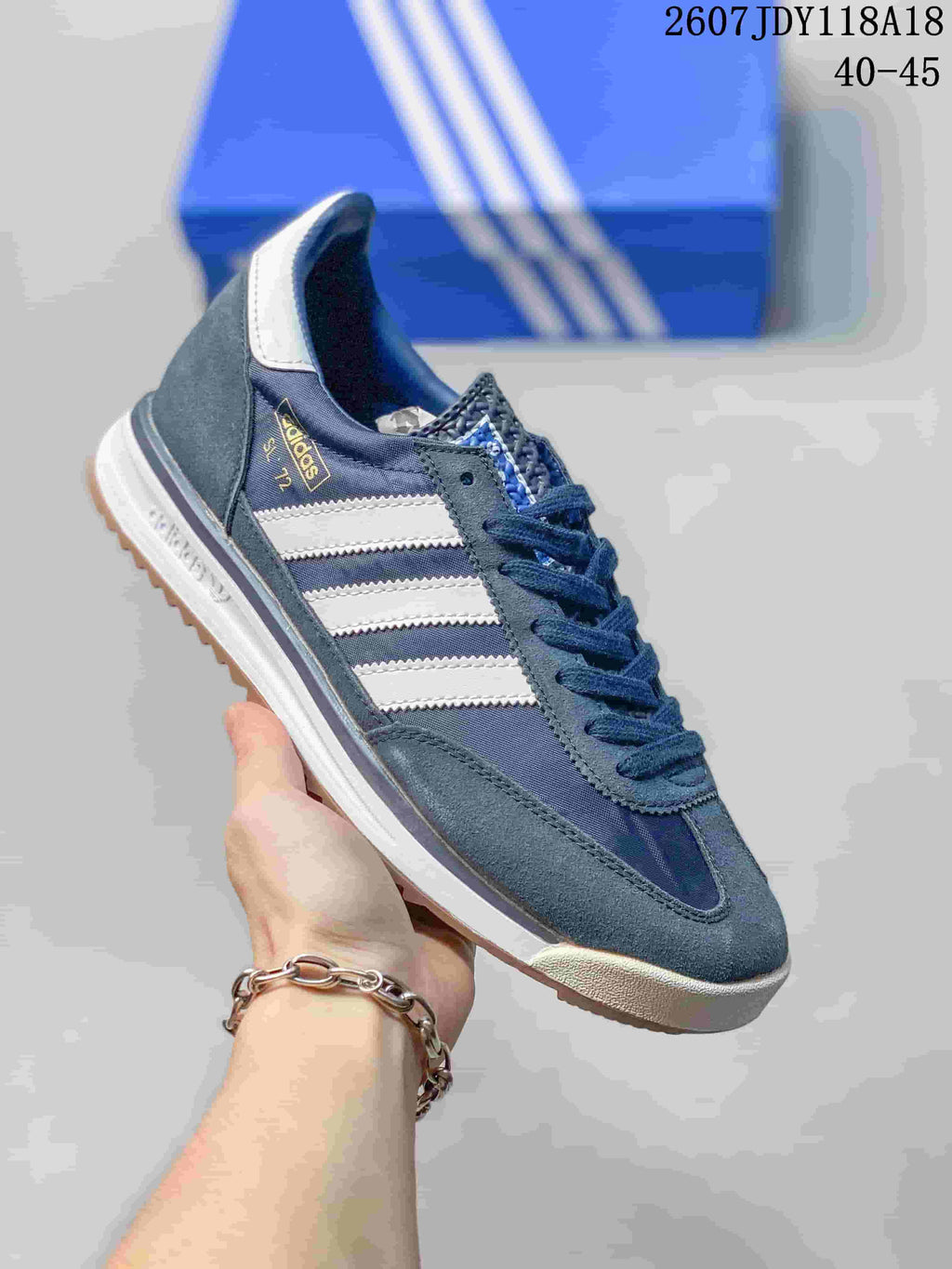 Navy and gray adidas SL 72 sneaker with white stripes and a light outsole.