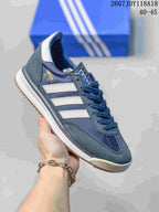 Navy and gray adidas SL 72 sneaker with white stripes and a light outsole.