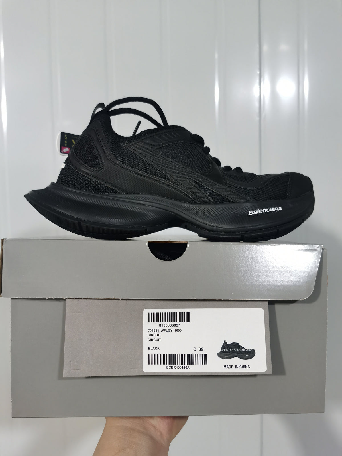 Black Balenciaga Circuit sneaker displayed on its box, with the box label showing style code 793944 WFLGY 1000 and size C 39.