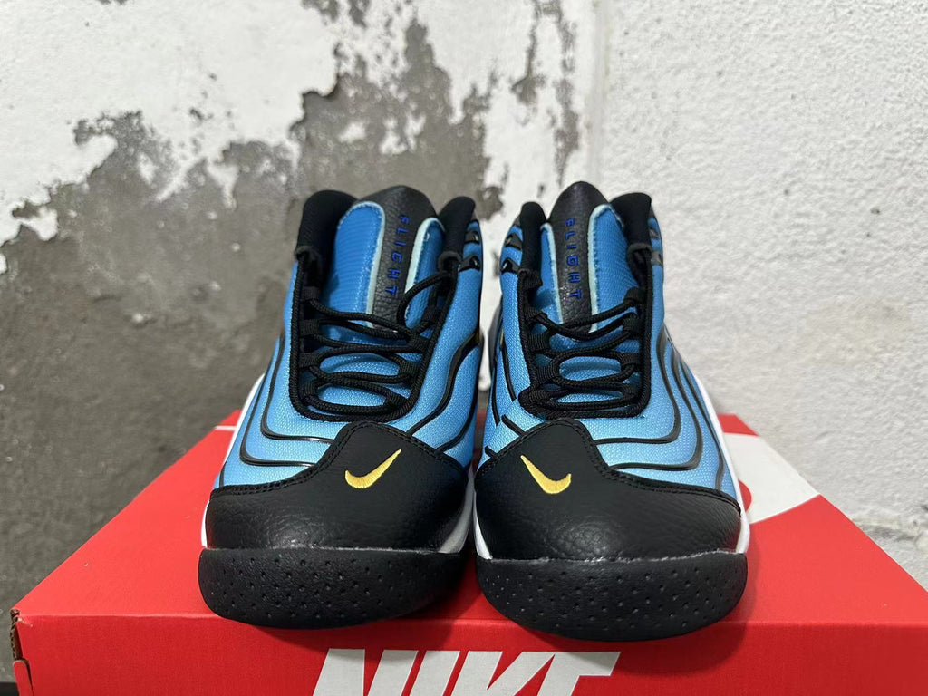 Front view of blue and black Nike sneakers with yellow Swoosh accents and lace-up closures.