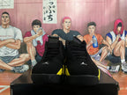 Front view of black high-top sneakers with yellow accents
