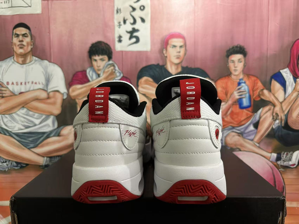 Rear view of white Jordan sneakers with red heel pull tabs, black collars, and red outsole details.
