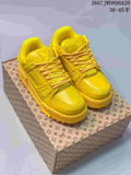 Pair of yellow Louis Vuitton Trainer Maxi sneakers displayed on a patterned shoe box, with the style code and size range visible above.