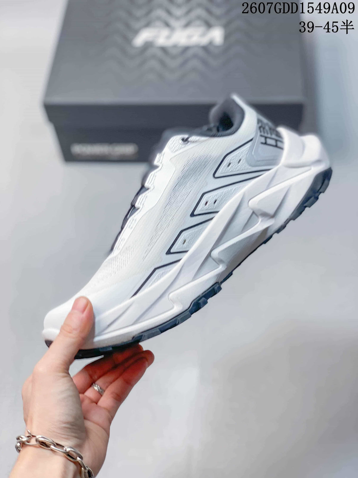 Side profile of the white Kailas shoe showing layered upper panels, geometric midsole shaping and dark outsole trim.