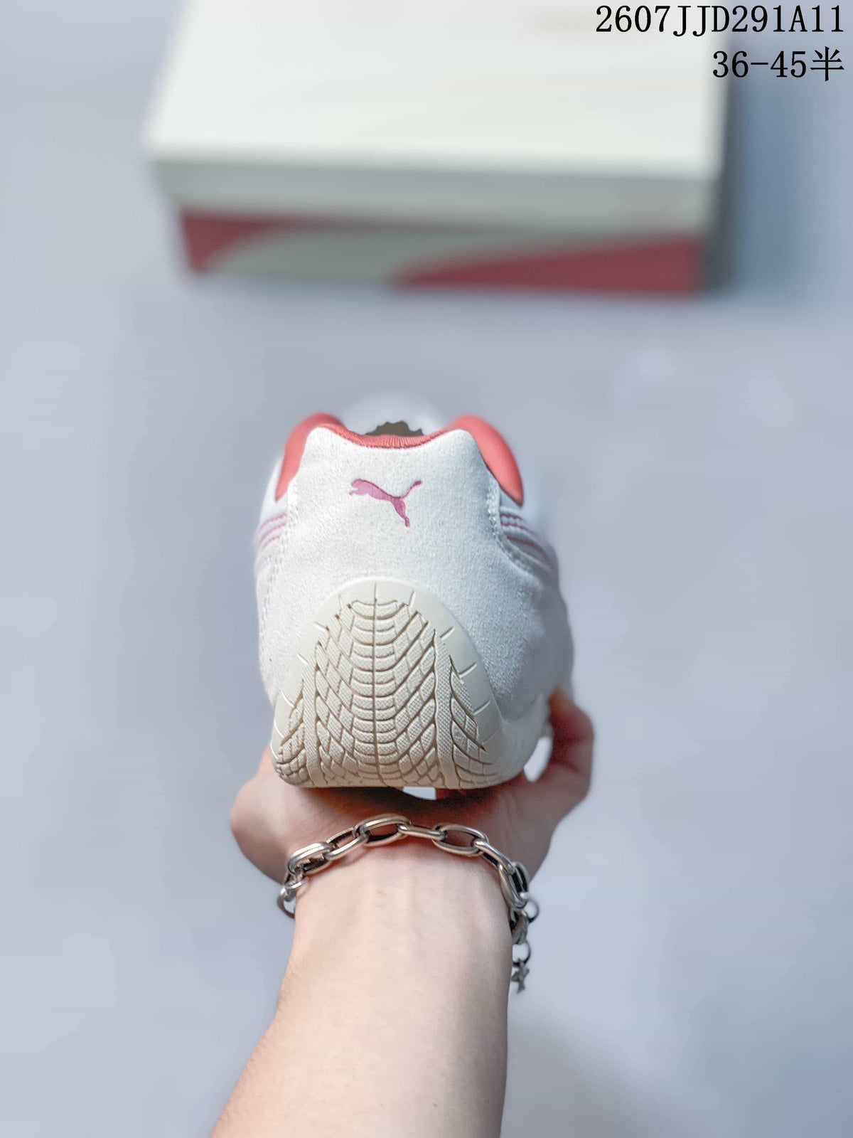 Rear view showing the white heel, pink Puma logo, and textured outsole.