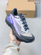 Angled side view of a Salomon Genesis trail running shoe with purple heel detailing and black outsole.