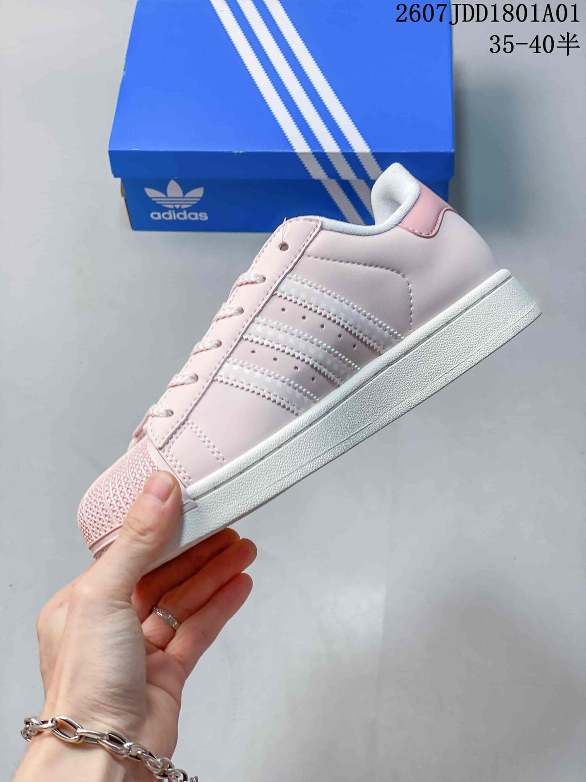 Side view showing the three stripes and flat white sole