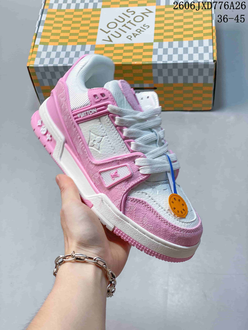 Angled side view of a pink and white low-top sneaker