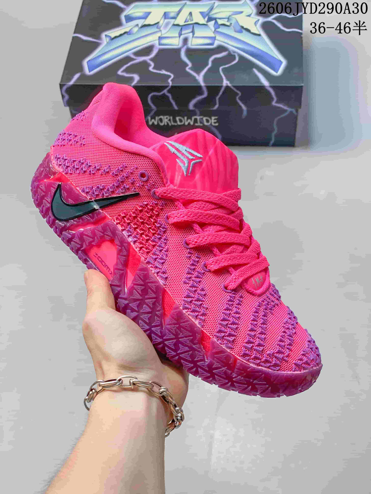 Bright pink Nike Ja 3 basketball shoe with dark accents