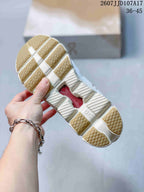 Underside view showing the segmented cream-colored outsole and central open section.
