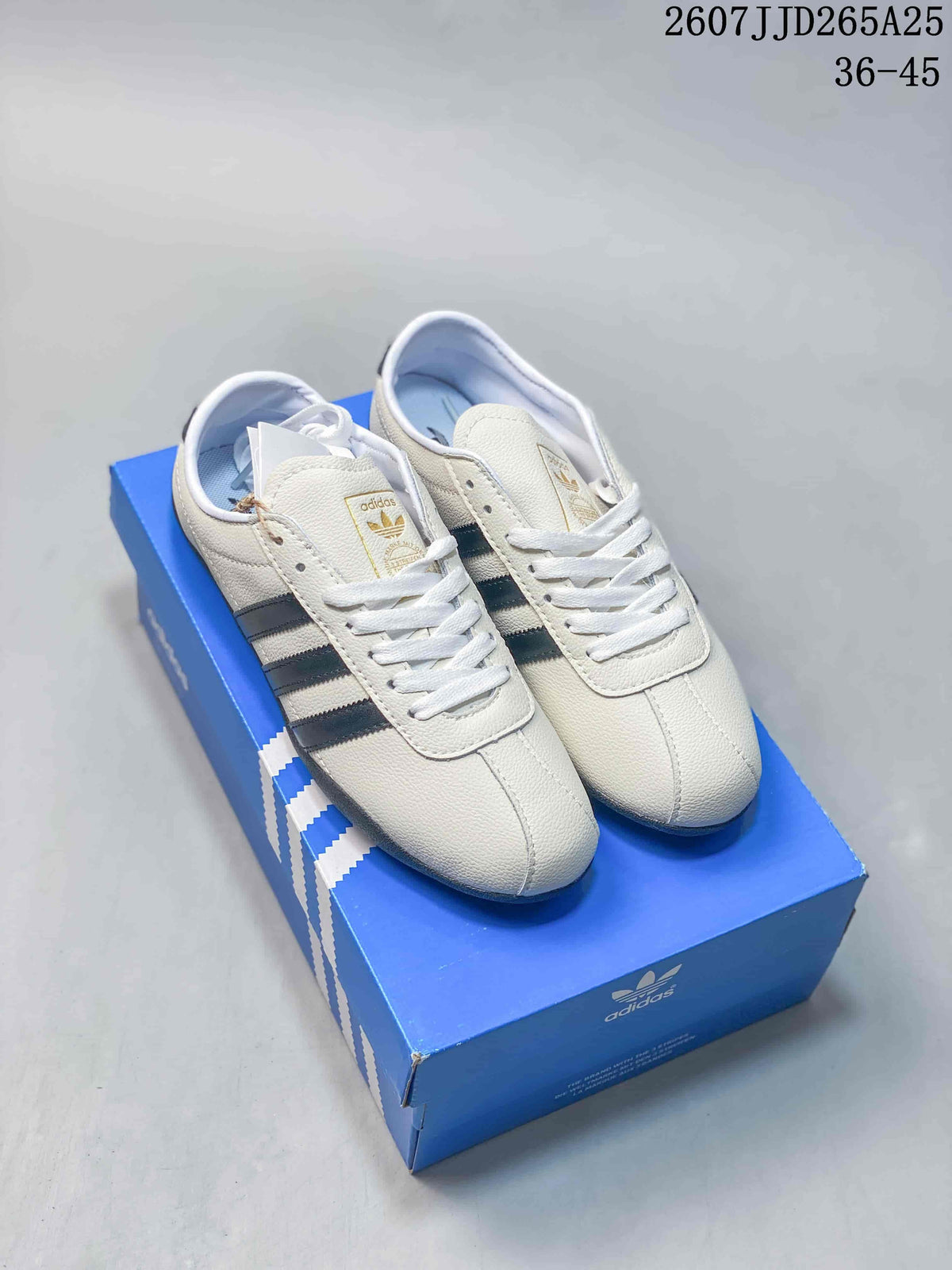 Pair of white adidas Tokyo low-top sneakers with black stripes displayed on a blue adidas shoebox; overlay shows 2607JJD265A25 and 36-45.