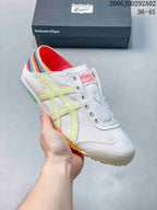 White Onitsuka Tiger slip-on sneaker with pale yellow stripes and a multicolor heel